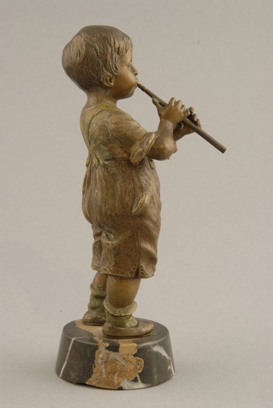A Vienna Bronze Figure of a young boy playing a fl