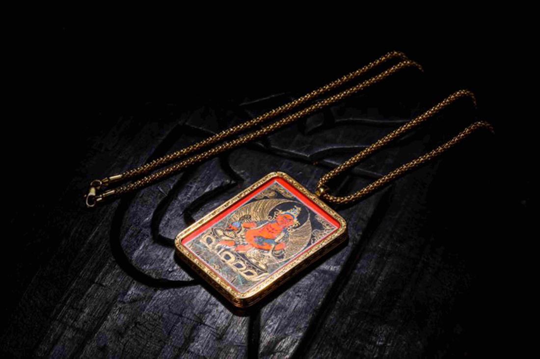 YELLOW ZAMBALA THANGKA AND ORIGINAL GAU BOX: Yellow Zambala Thangka with original gau box: Height: 5.2cm, Width: 3.75