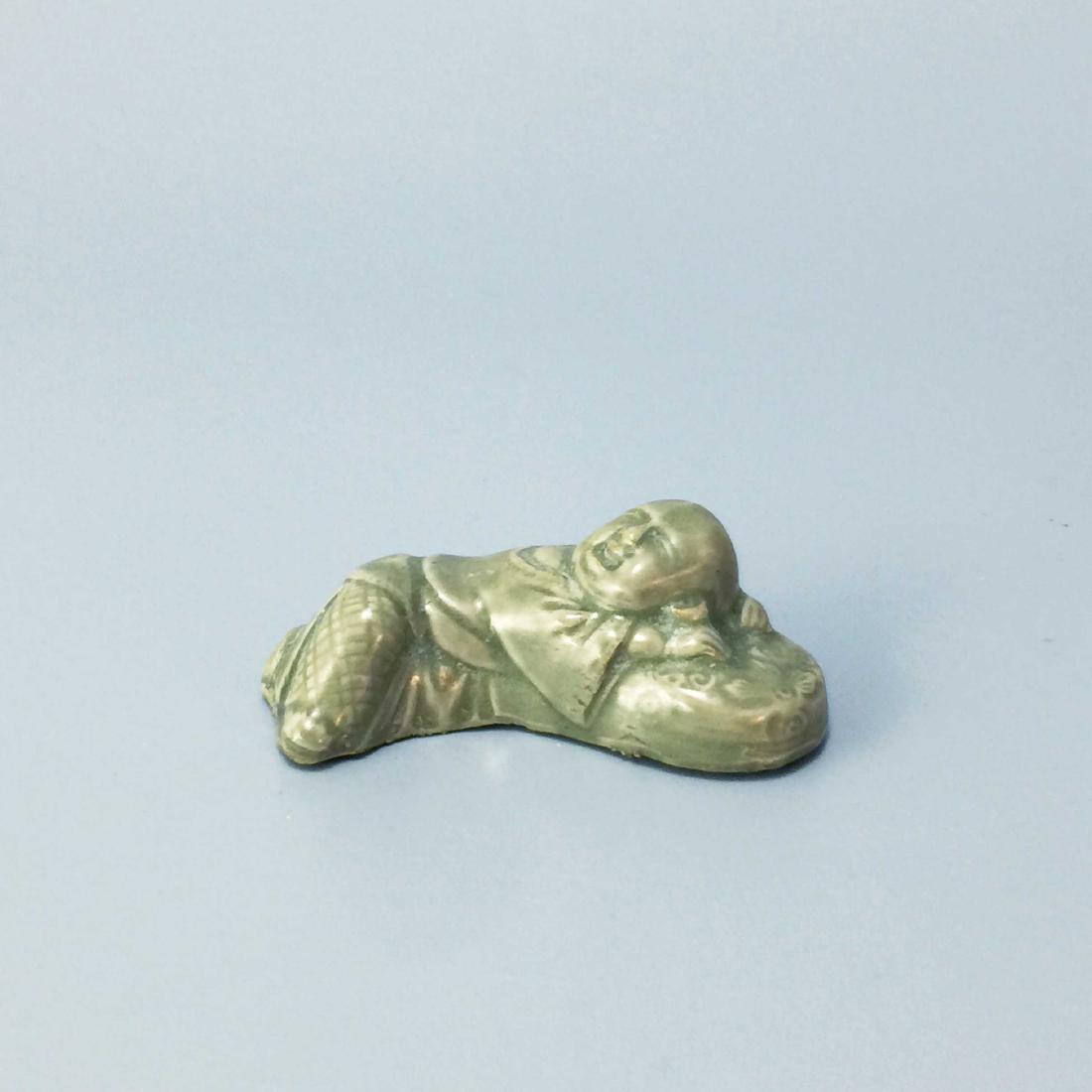 YAOZHOU KILN GREEN GLAZE BOYS PEN HOLDER: Yaozhou kiln green glaze boys pen holder.Height: 3cm Length: 8.5cm