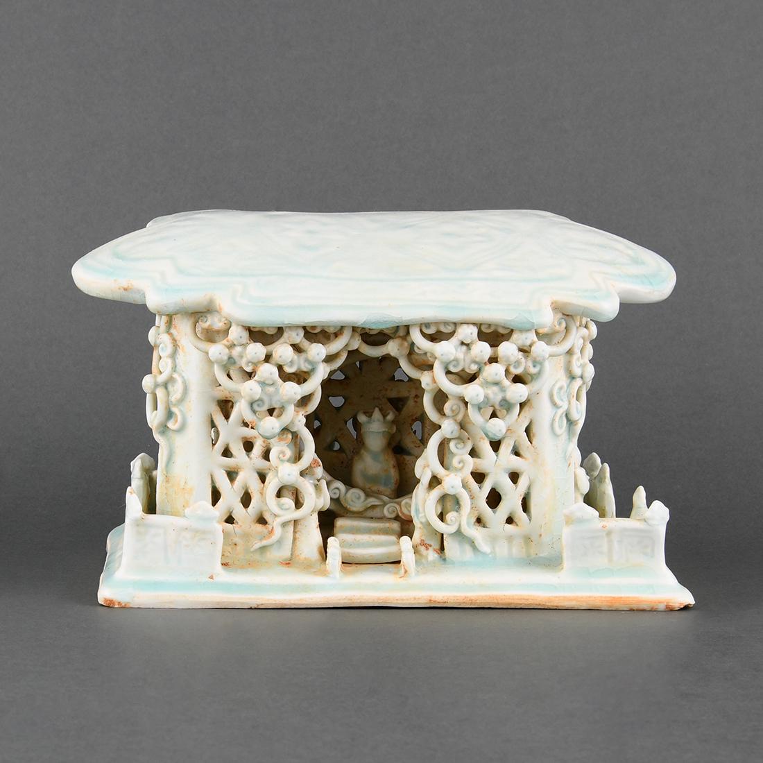 A QINGBAI-GLAZED 'PLAY SCENE' PILLOW: A QINGBAI-GLAZED 'PLAY SCENE' PILLOWwith the design of opera and stage by Yuan-styleL:26.6cm,W:16.4cm,H:16.2cm