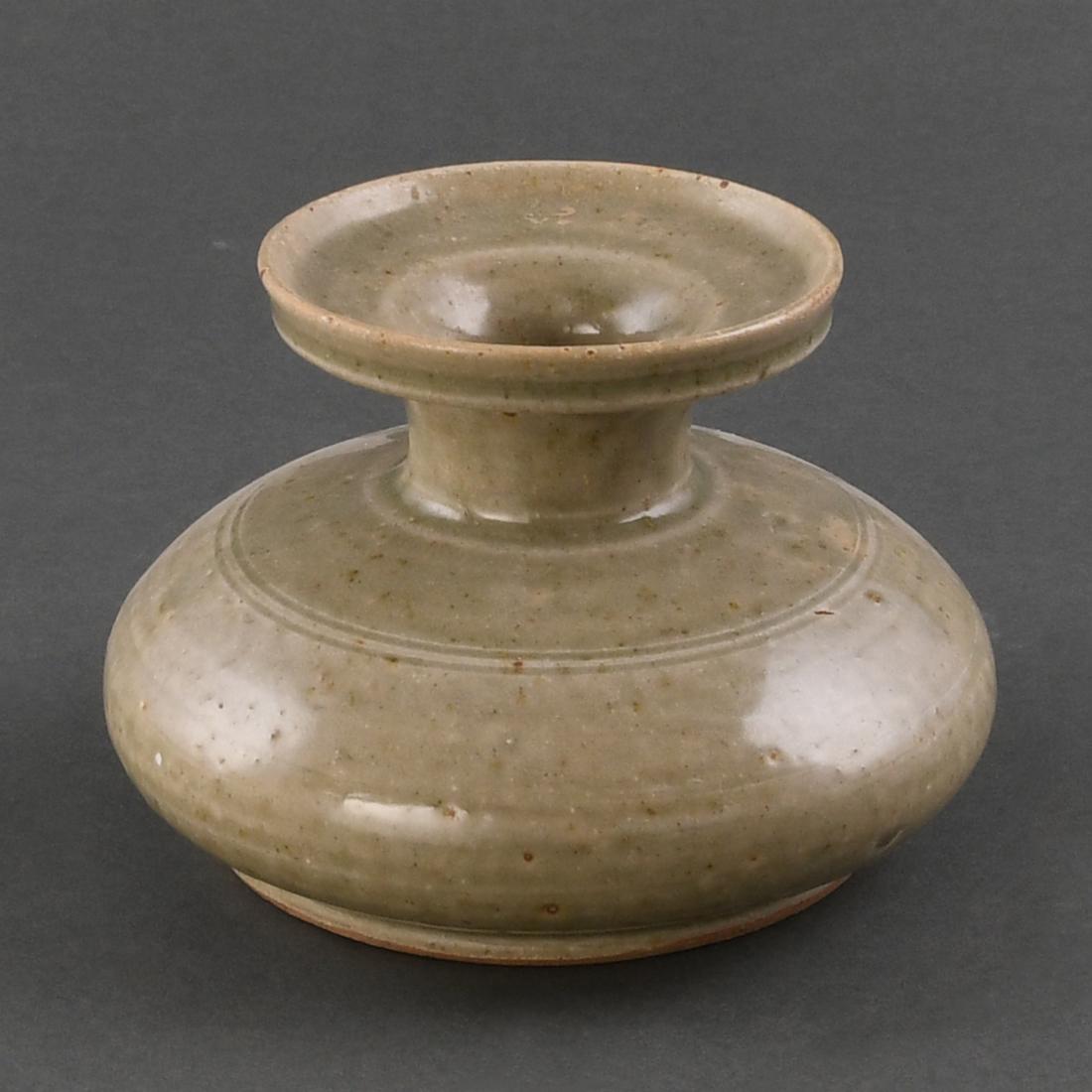 A 'YUE' CELADON-GLAZED STONEWARE VASE: A 'YUE' CELADON-GLAZED STONEWARE VASE Size: H:10.3cm,W:15.1cm,Diam.of mouth:9.6cm The tapered ovoid body rising to a short neck with wide stepped and galleried rim, a band of incised lines encircling 