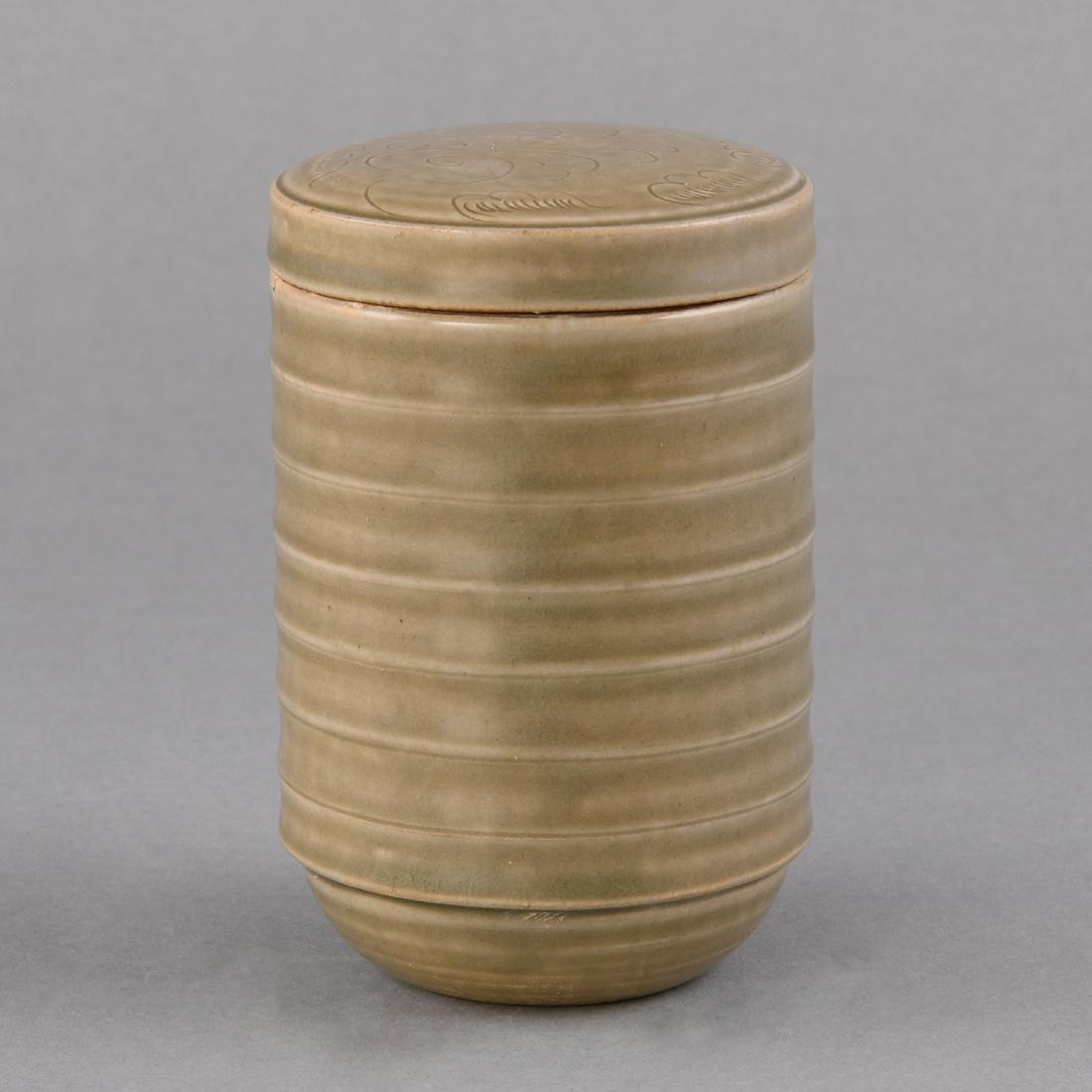 A 'YUE' CELADON CARVED RIBBED BOX ANDCOVER: A 'YUE' CELADON CARVED RIBBED BOX AND COVER Size: Dia:8.5cm, H:13.1cm