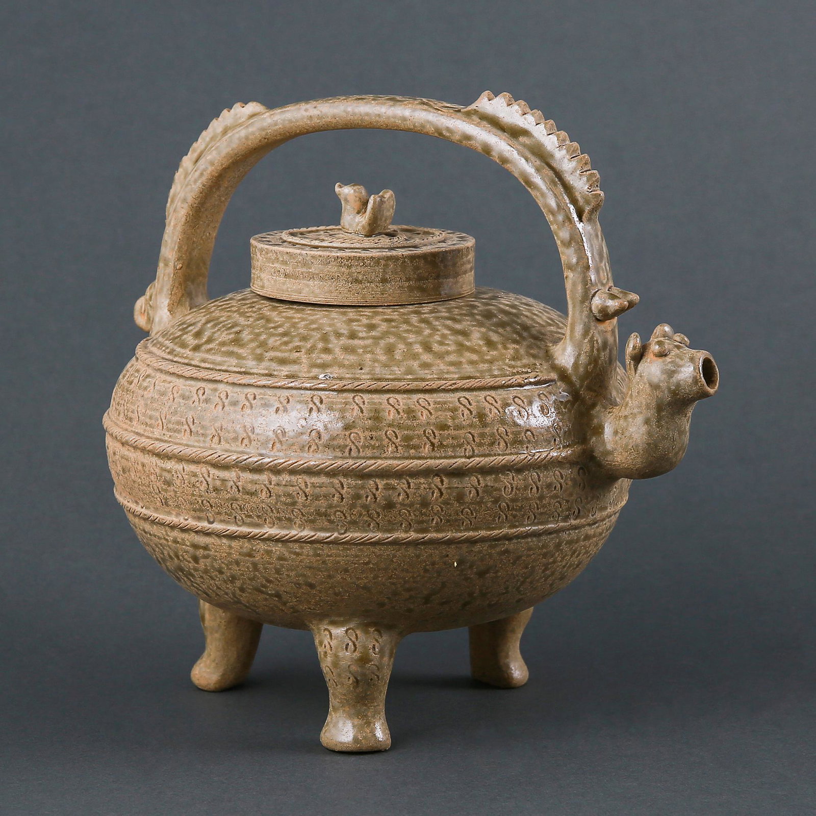 A 'YUE' CELADON TRIPOD HANDLE EWER (1 of 7)