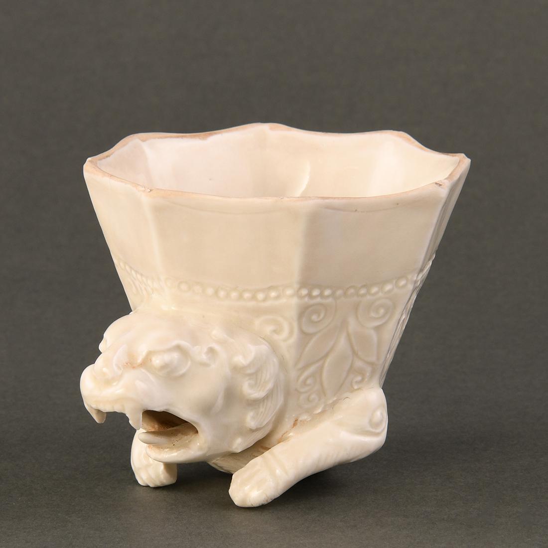 A 'XING' WHITE-GLAZED 'LION' RHYTON (1 of 9)