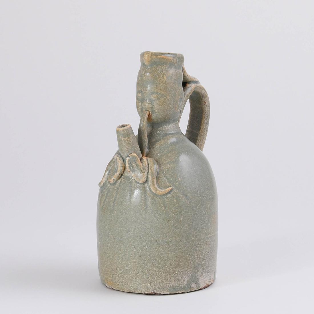 A RARE 'YUE' CELADON 'MUSICIAN' EWER (1 of 8)
