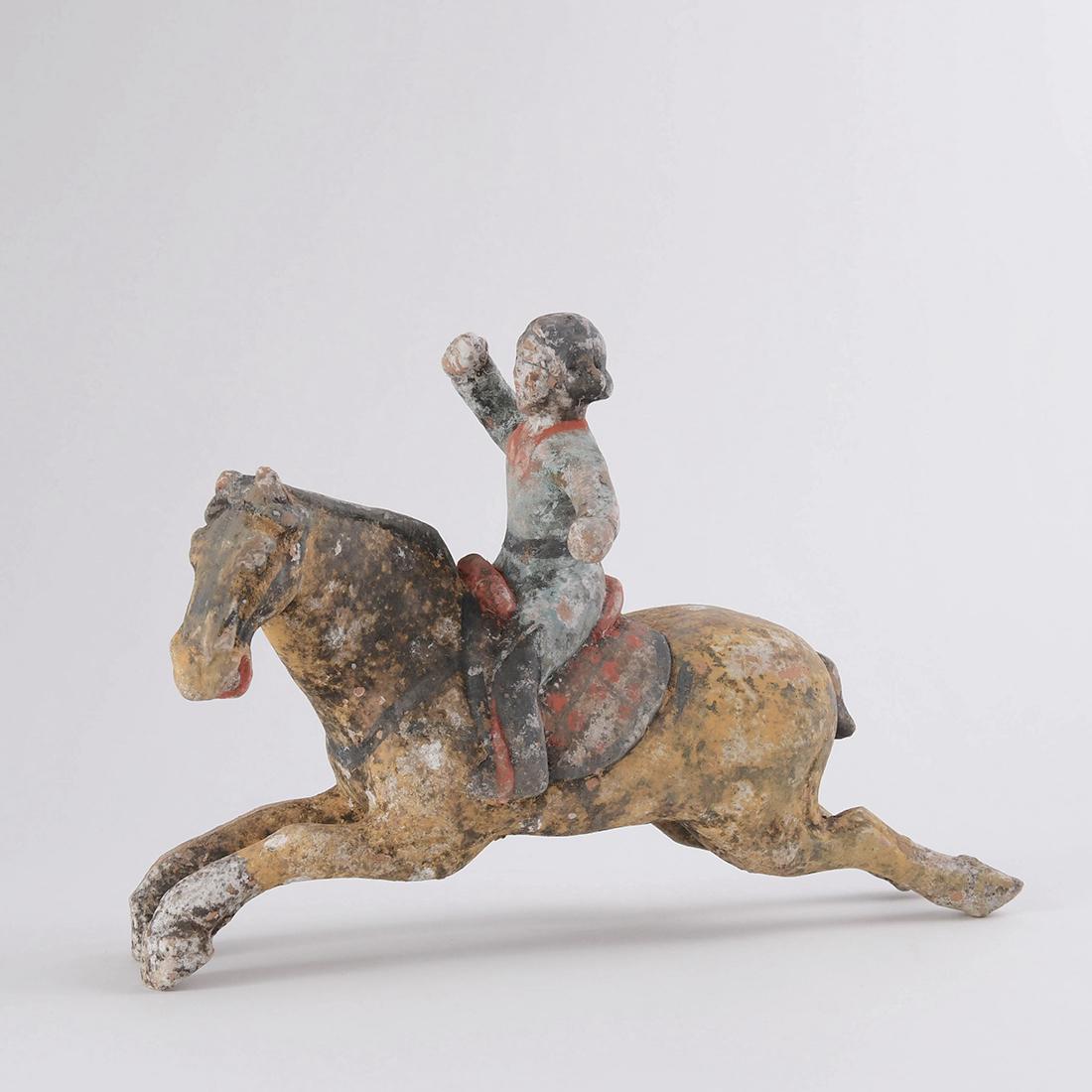 A PAINTED POTTERY FIGURE OF POLO PLAYER (1 of 7)