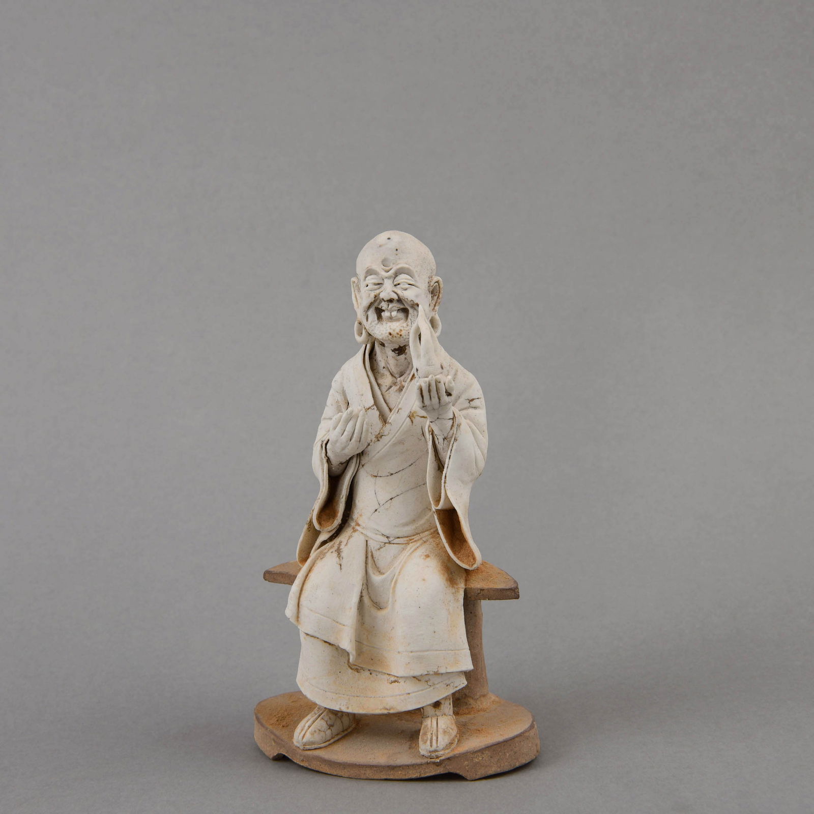 A 'QINGBAI' BISCUIT FIGURE OF A LUOHAN (1 of 9)