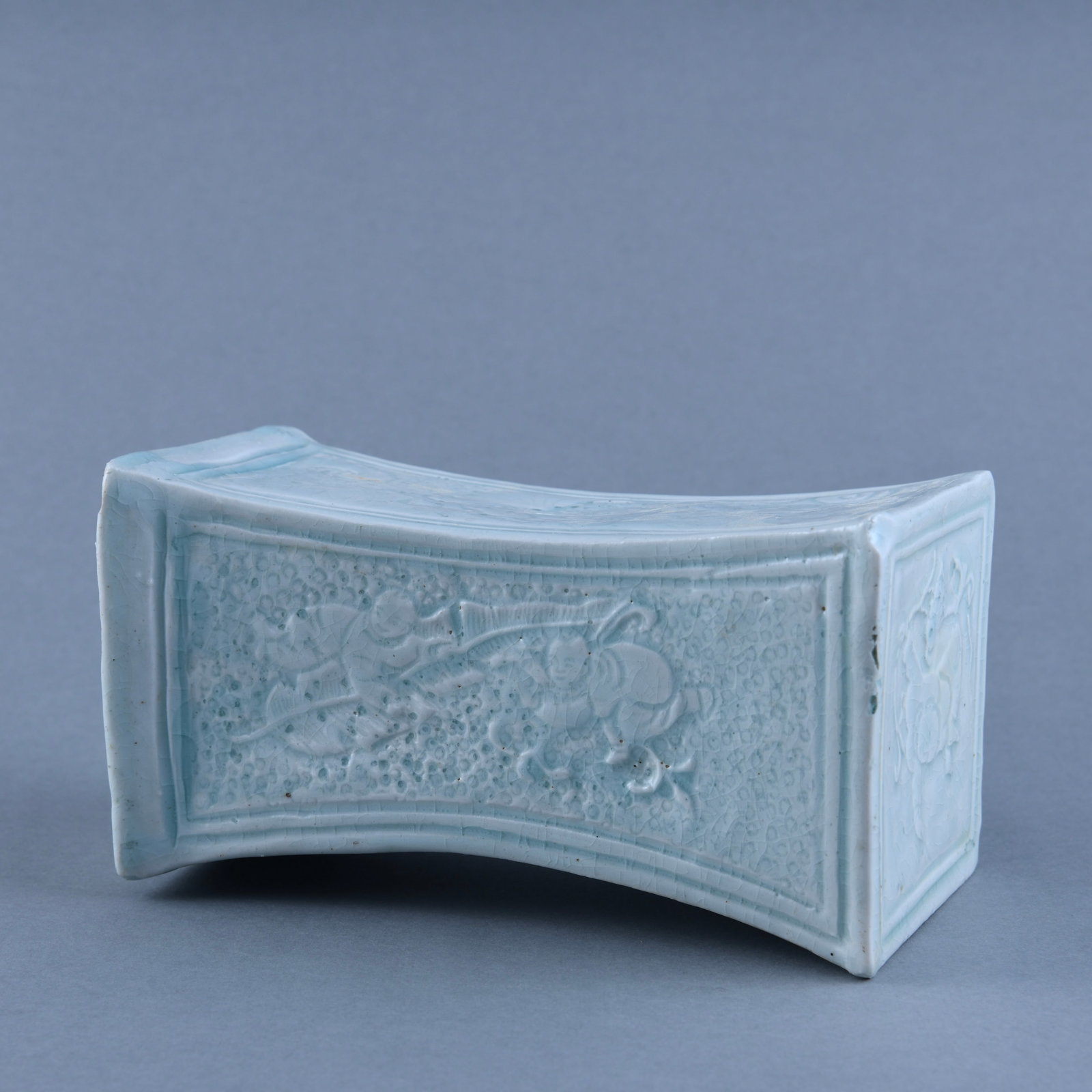 A FINE QINGBAI 'BOY' PILLOW: A FINE QINGBAI 'BOY' PILLOW H:10.9cm, W:20.2cm