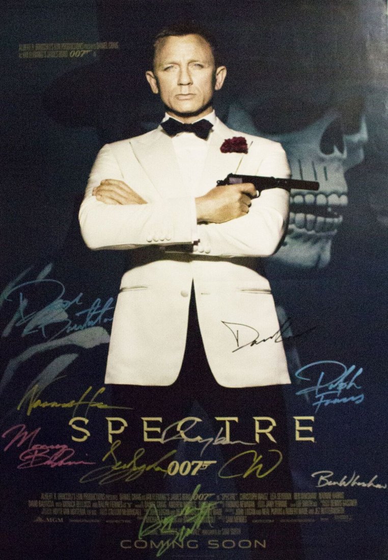James Bond Spectre - Signed Photo in Movie Poster: Signed by Daniel Craig, Ralph Fiennes, Christoph Waltz, Monica Bellucci, Dave Bautista, Naomie Harris, Lea Seydoux, Ben Whishaw, Rory Kinnear, and Andrew Scott. High gloss stock paper in wood framing
