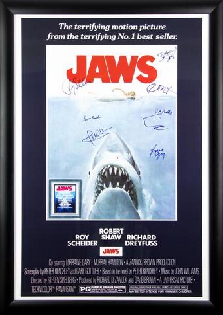 Jaws - Signed Movie Poster: Signed by Roy Scheider, Richard Dreyfuss, Lorraine Gary, Susan Backlinie, composer John Williams and director Steven Spielberg High gloss stock paper in wood framing with UV protective acrylic glass A