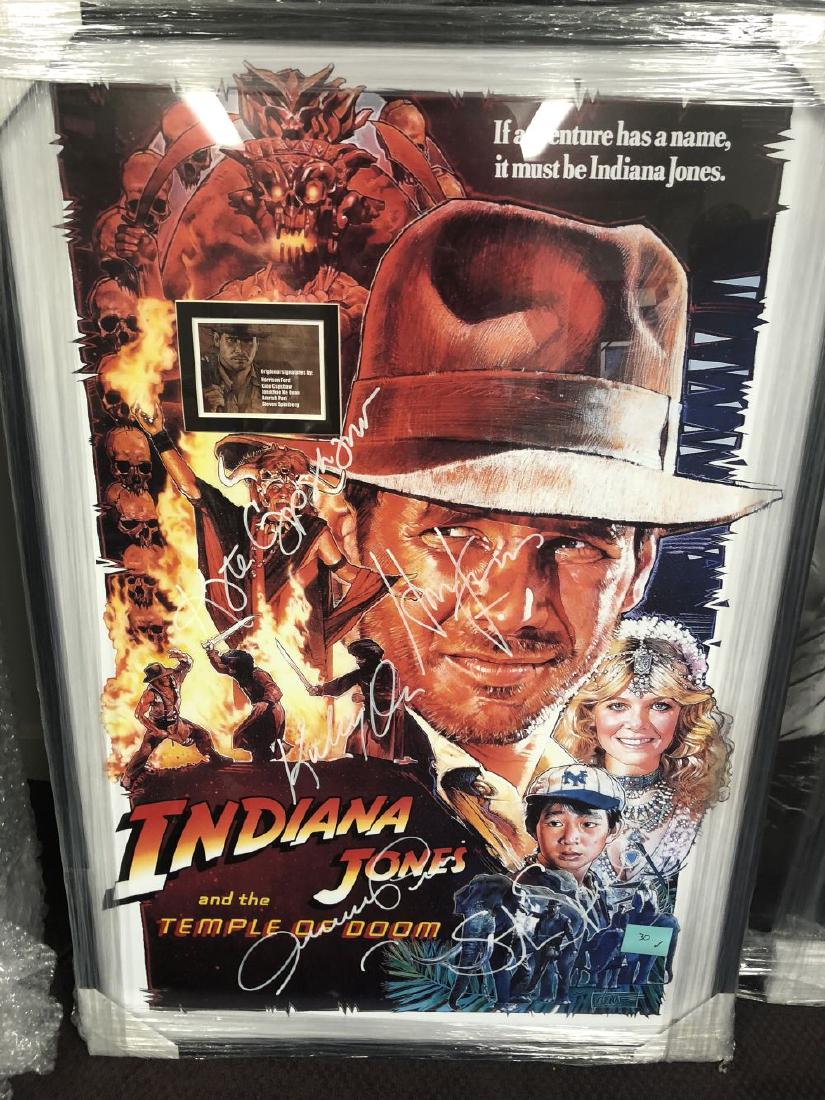 Indiana Jones and the Temple of Doom - Signed Movie: Signed by Harrison Ford, Kate Capshaw, Key Huy Quan, composer John Williams, producer George Lucas and director Steven Spielberg High gloss stock paper in wood framing with UV protective acrylic glass