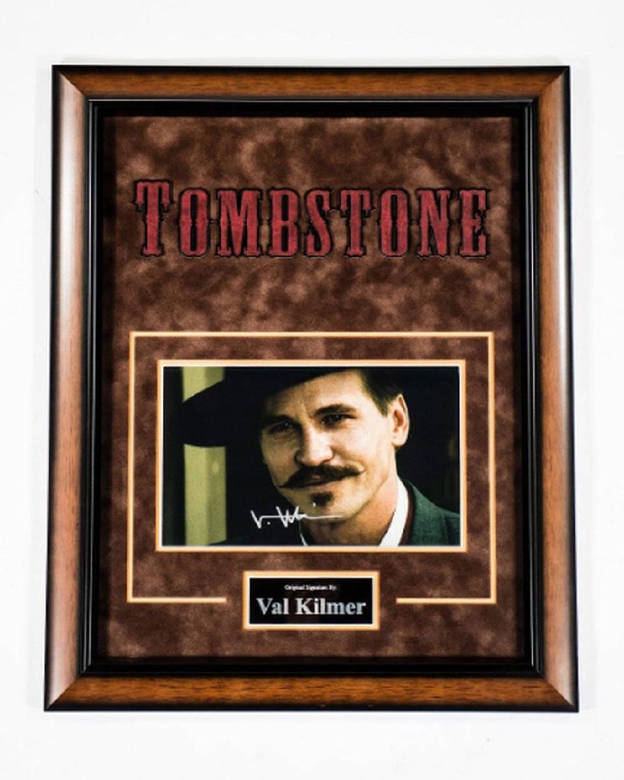 Val Kilmer Signed Tombstones Photo: Signed photo by Val Kilmer (Doc Holliday) Custom mounted and framed with graphic nameplate. Procurement, authentication and framing may take up to 3 weeks. All contemporary autographed items are obtai