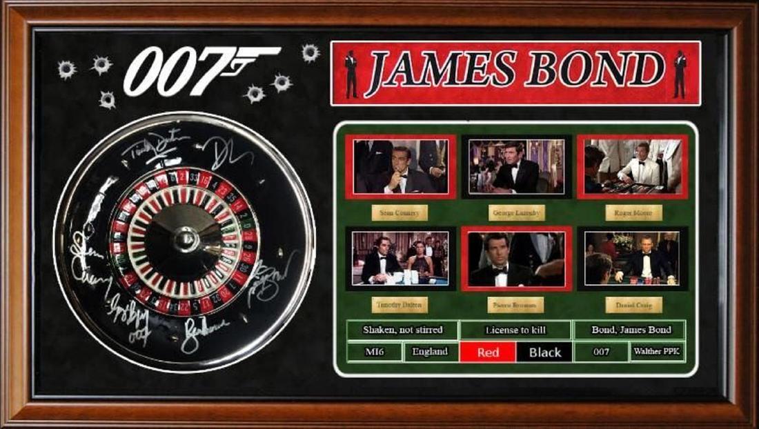 James Bond Signed Roulette Wheel and Collage: This is one of THE coolest "Bond" pieces we have put together. A mini-roulette wheel display signed by: Sean Connery, George Lazenby, Roger Moore, Timothy Dalton, Pierce Brosnan, Daniel Craig. This is