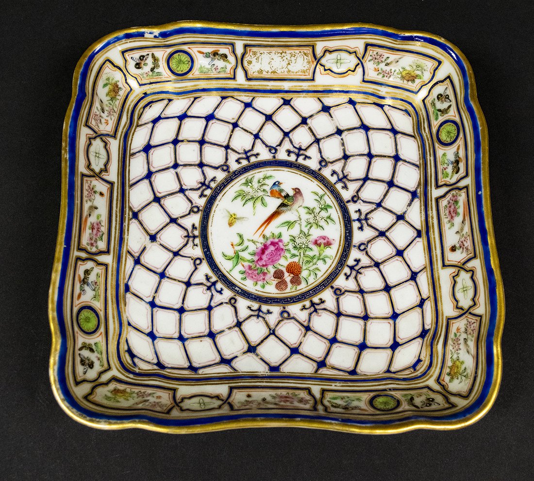 Diminutive Chinese Export Platter 19th Century: Very unique Chinese export platter features net design with floral and exotic bird motif. Poly-chrome --white with cobalt blue, pink, green, with gold accents. Minor wear along edges. 19th century.