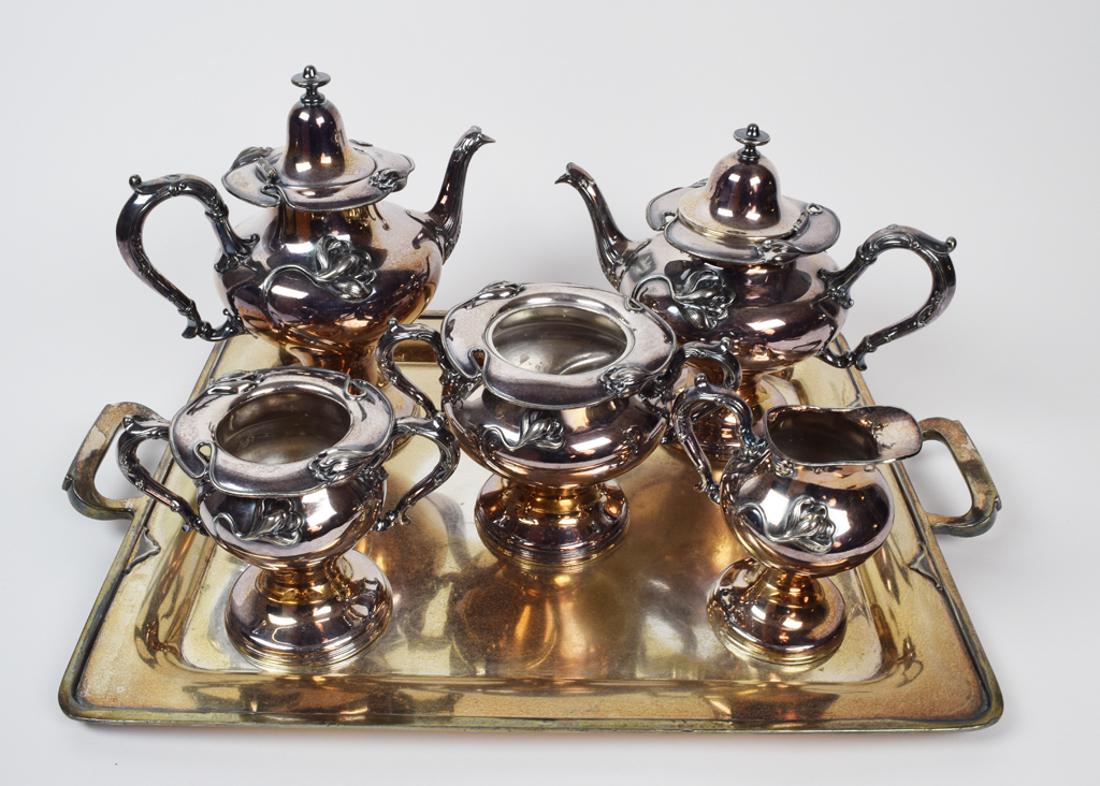 Art Nouveau Style Coffee and Tea Service: Plated Coffee/ Tea set. Silver Plated, from the Victor Silver Company, stamped "2671 PAT. June. 14. 1904" Two Coffee/Tea pots, three condiment dispensers, and platter. 10" Tallest, Tray: 15.5 x 18.5.