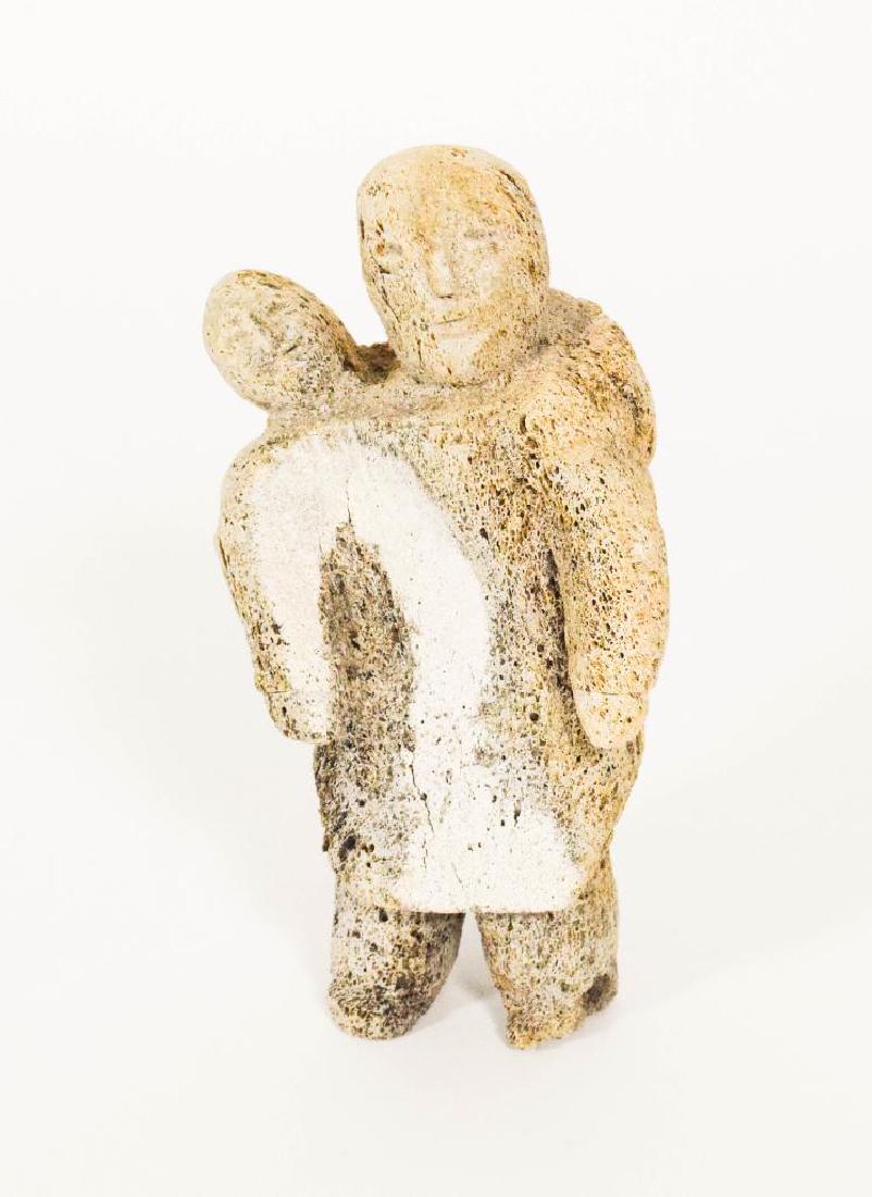 Inuit Whale Bone Carving: Inuit whale bone carving of a woman carrying a child .Early 20th century, 11" Tall.