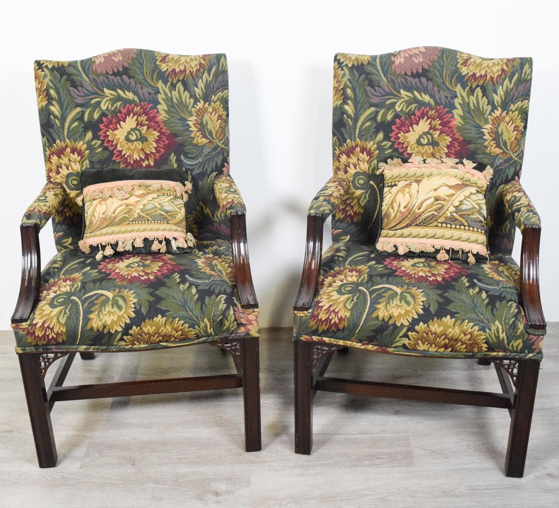 Pair of George III Style Library Chairs: Pair of George III Style Upholstered Mahogany Library Armchairs. Arched crest raised on molded legs joined with stretchers. Height 40" Width 24" Depth 19"