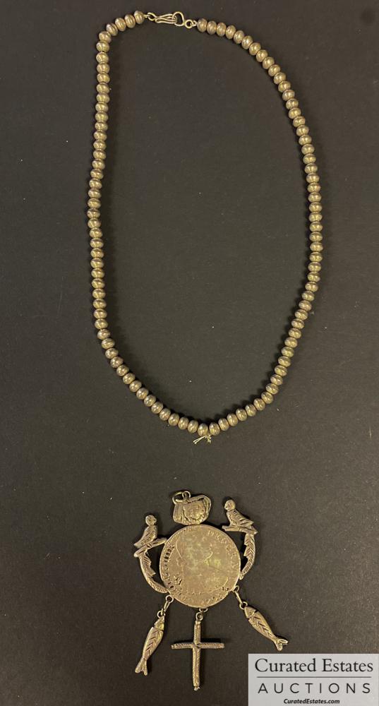 Elaine Steinbeck's Sterling Silver Necklace: 1795 8 reale "Spanish piece of eight" mounted as a pendant. A cross, fish and birds affixed to coin. With a chain of silver beads. 2.6 OZ Estate of John and Elaine Steinbeck