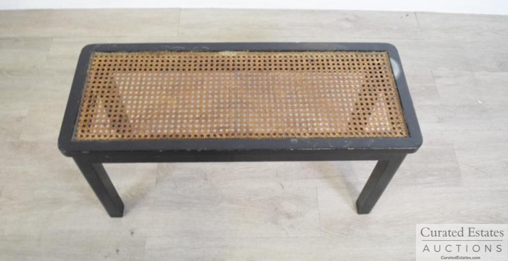 Black Bench With Canned Seat: Black bench with canned seat. Wear throughout. Dimensions: 30 " L x 12 " W x 15 " H Provenance: From the Estate of John and Elaine Steinbeck