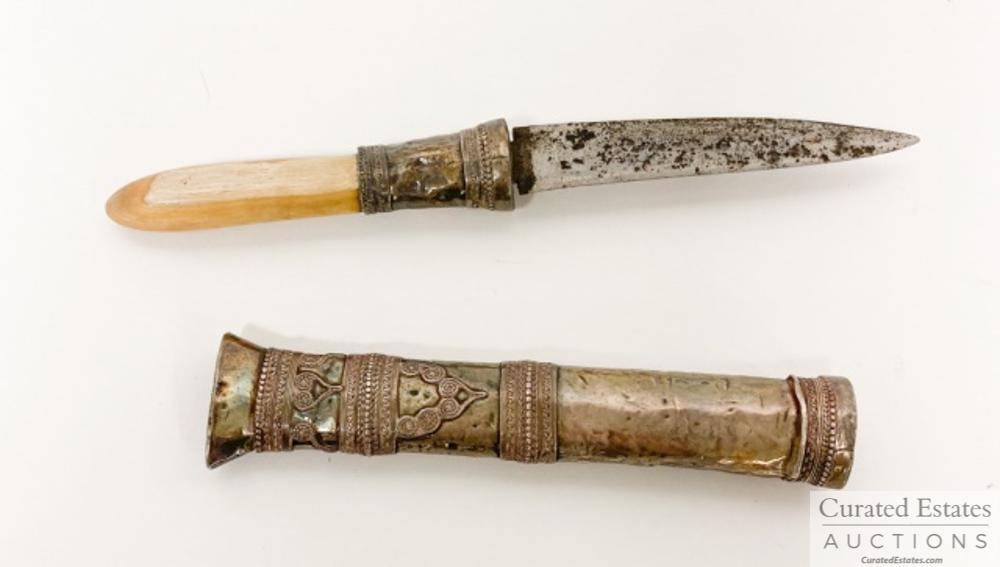 John Steinbeck's Silver Dha Dagger: Dha dagger from the Shan people of South East Asia. Sheath and guard of silver with applique scroll work. A gift to John Steinbeck from Elaine Steinbeck "Knife (Ivory & Silver) from Loas, E to J" Elai
