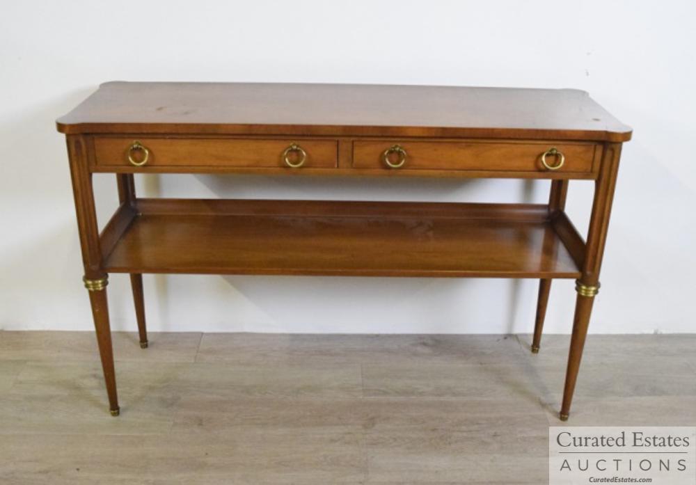 Baker Empire Style Console Table: Two drawer empire style console table. Mahogany with brass hardware. Baker Furniture metal tag inside of drawer. Dimensions: 46 1/4 " L x 15 " W x 29 1/2" H Provenance: From the Estate of Elaine Stein