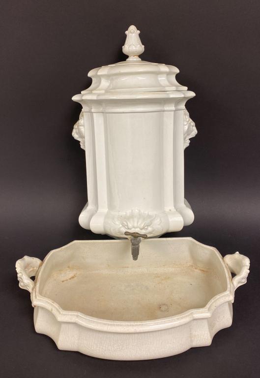 White Ceramic Lavabo: White ceramic lavabo. Classical motifs throughout. Metal spigot protruding from dolphin face in water tank. A picture of Lavabo in Steinbeck Apartment included with this lot as well as a copy of the h