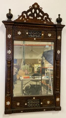 Carved and Inlaid Moorish Mirror: Carved mirror with mother of pearl inlays. 37 1/2" Tall 10 1/4" Wide. Missing some mother of pearl