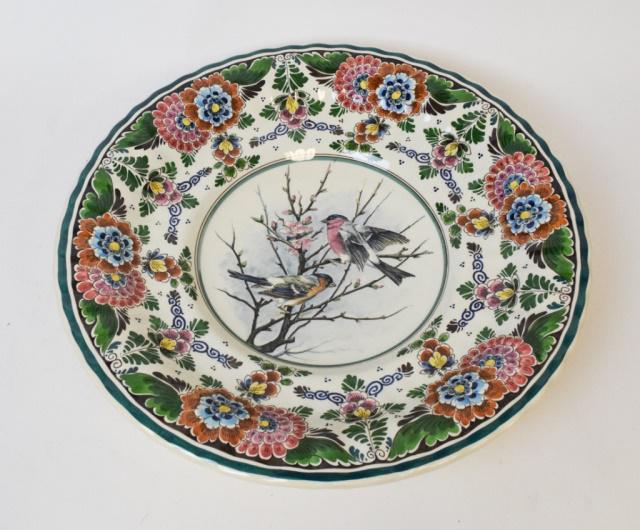 Large Delft Platter with Bird Motif: Large multi colored Delft Holland platter with bird design in center and floral pattern throughout. 20"dia