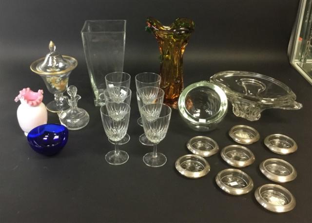 22 Piece Glass Lot: Square vase, ruffled vase, etched decanter, covered compote, 3 art glass vases, cobalt bowl, 8 Whiting sterling rimmed coasters, 6 pieces of matching stemware. Chip on lid of compote. Square vase 12"