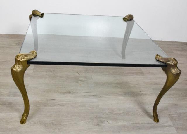 Bronze Low Table: Glass inset top raised on a scroll base. Height 15" width 40"