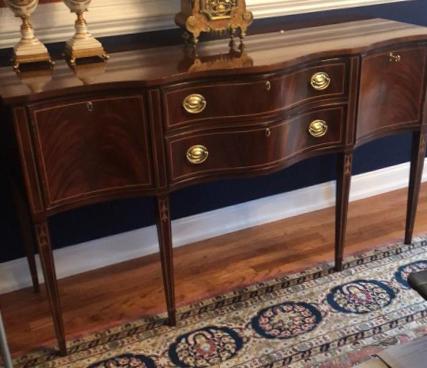 Federal Style Side Board: Serpentine front with two drawers flanked by two doors. Book matched drawer and door fronts. Inlays throughout. Gilt escutcheons and drawers pulls. Comes with one key. Right door escutcheon not attach