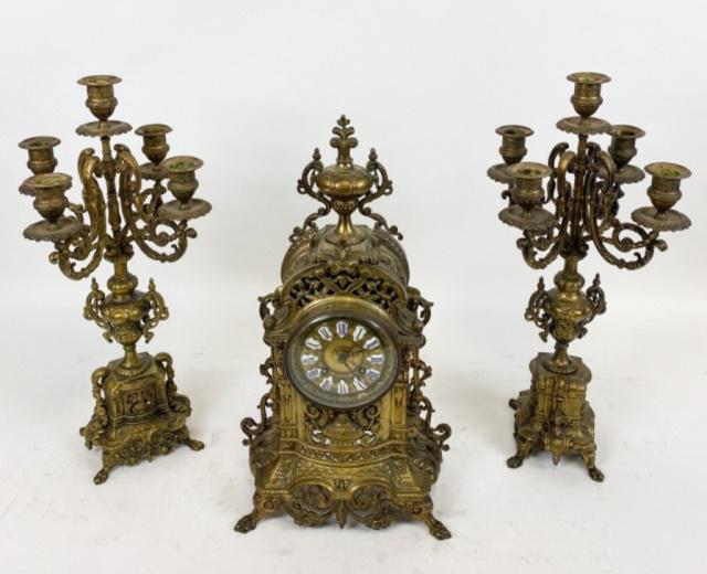 C Cellier Gilt Bronze Mantel Clock & Garniture: Renaissance revival style gilt bronze mantel set, France, c. 1880 A clock with an elaborate bronze case, with crown, over circular face, with blue roman numerals on white enamel. Has pendulum, key, an