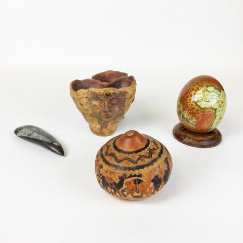 Mixed Lot of Porcelain, Wood and Marble: Mix of (1) Marble with Scrimshaw Style Design, (1) Porcelain Bowl in Red with Face on Front, (1) Persian Design on gourd, and (1) ostrich egg with a Map of Africa and Animals Painted on the Egg on a W