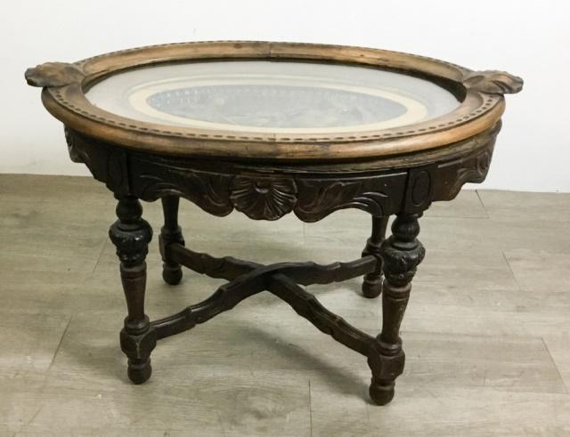 Renaissance Revival Carved Side Table: Top Carved with mythical figures. Crossed stretchers with shell decoration. 30 1/2"L x 19"W x 19 3/4"H npu-rl