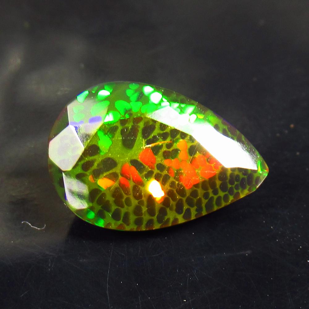 4.08 Ct Natural Black Fire Opal Loose Stone: Weight - 4.08 Ct / Size - 14.50 x 9.70 x 7.20 mm / Shape - Pear Cut / Color - Black / Clarity - Translucent / Origin - Ethiopia / Treatment - Heated