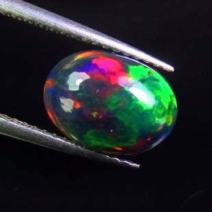 1.77 Ct Natural Black Fire Opal Loose Stone: Weight - 1.77 Ct / Size - 10.90 x 8.00 x 4.00 mm / Shape - Oval Cab / Color - Black / Clarity - Translucent / Origin - Ethiopia / Treatment - Heated