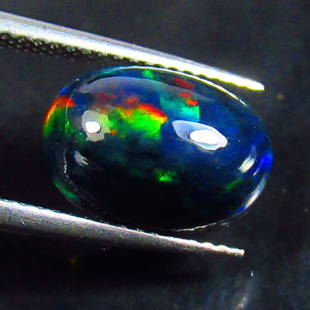 2.71 Ct Natural Black Fire Opal Loose Stone: Weight - 2.71 Ct / Size - 12.40 x 8.90 x 5.80 mm / Shape - Oval Cab / Color - Black / Clarity - Translucent / Origin - Ethiopia / Treatment - Heated