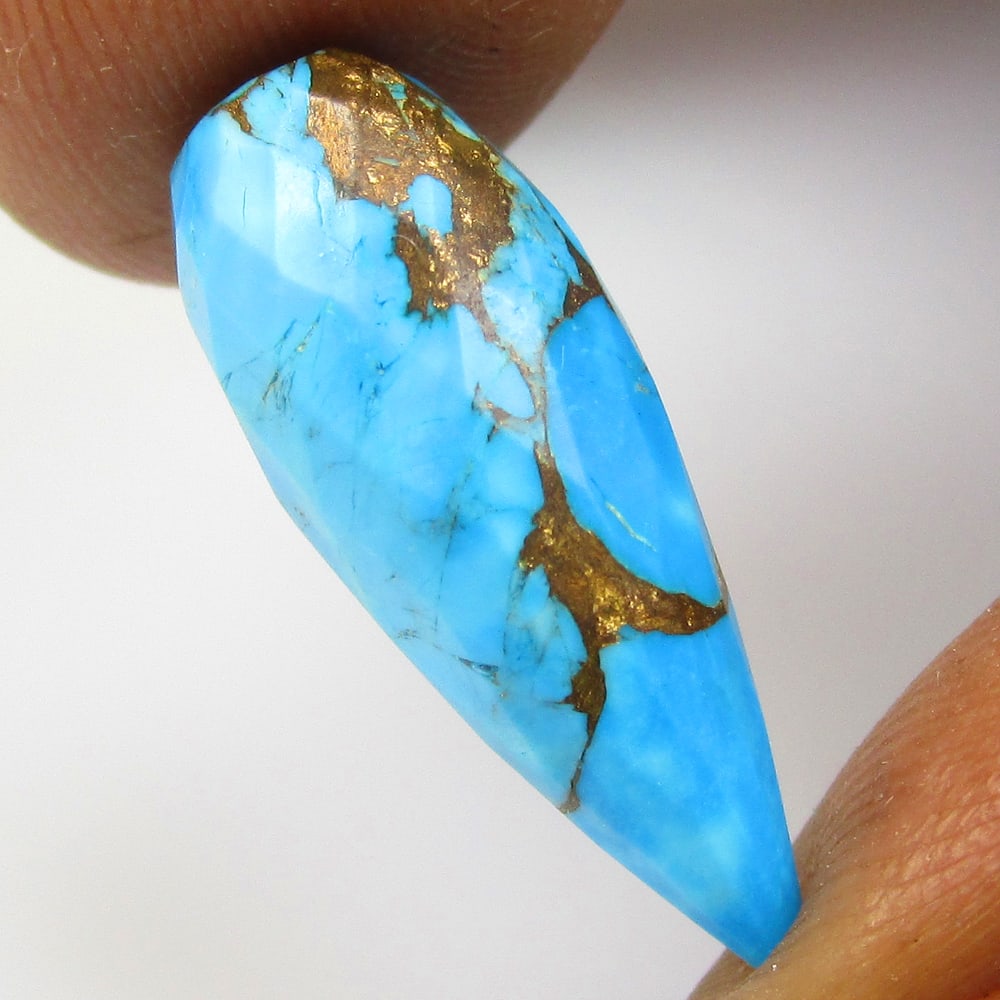 7.74 Ct Composite Howlite Loose Stone: Weight - 7.74 Ct / Size - 21.50 x 8.00 x 8.00 mm / Shape - Pear Drop / Color - Blue / Clarity - OPaque / Origin - Brazil / Treatment - Dyed