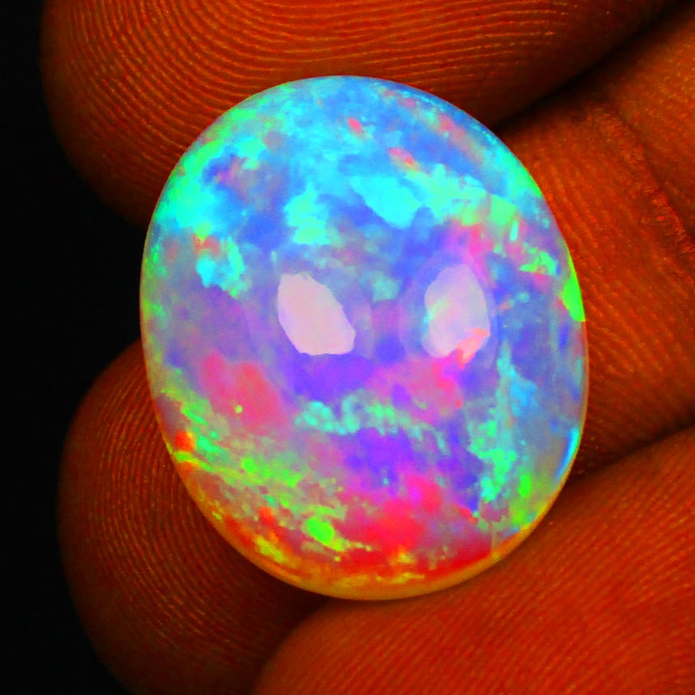 8.04 Ct Natural Multi-Color Fire Opal Loose Stone: Weight - 8.04 Ct / Size - 18.30 x 15.00 x 6.60 mm / Shape - Oval Cab / Color - Multicolor / Clarity - Translucent / Origin - Ethiopia / Treatment - None