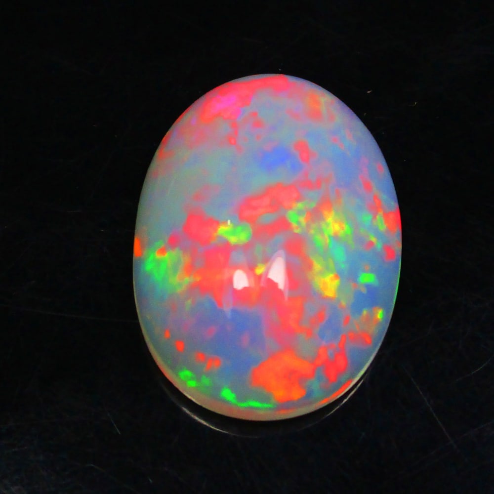 6.37 Ct Natural Multi-Color Fire Opal Loose Stone: Weight - 6.37 Ct / Size - 18.10 x 12.90 x 6.20 mm / Shape - Oval Cab / Color - Multicolor / Clarity - Translucent / Origin - Ethiopia / Treatment - None