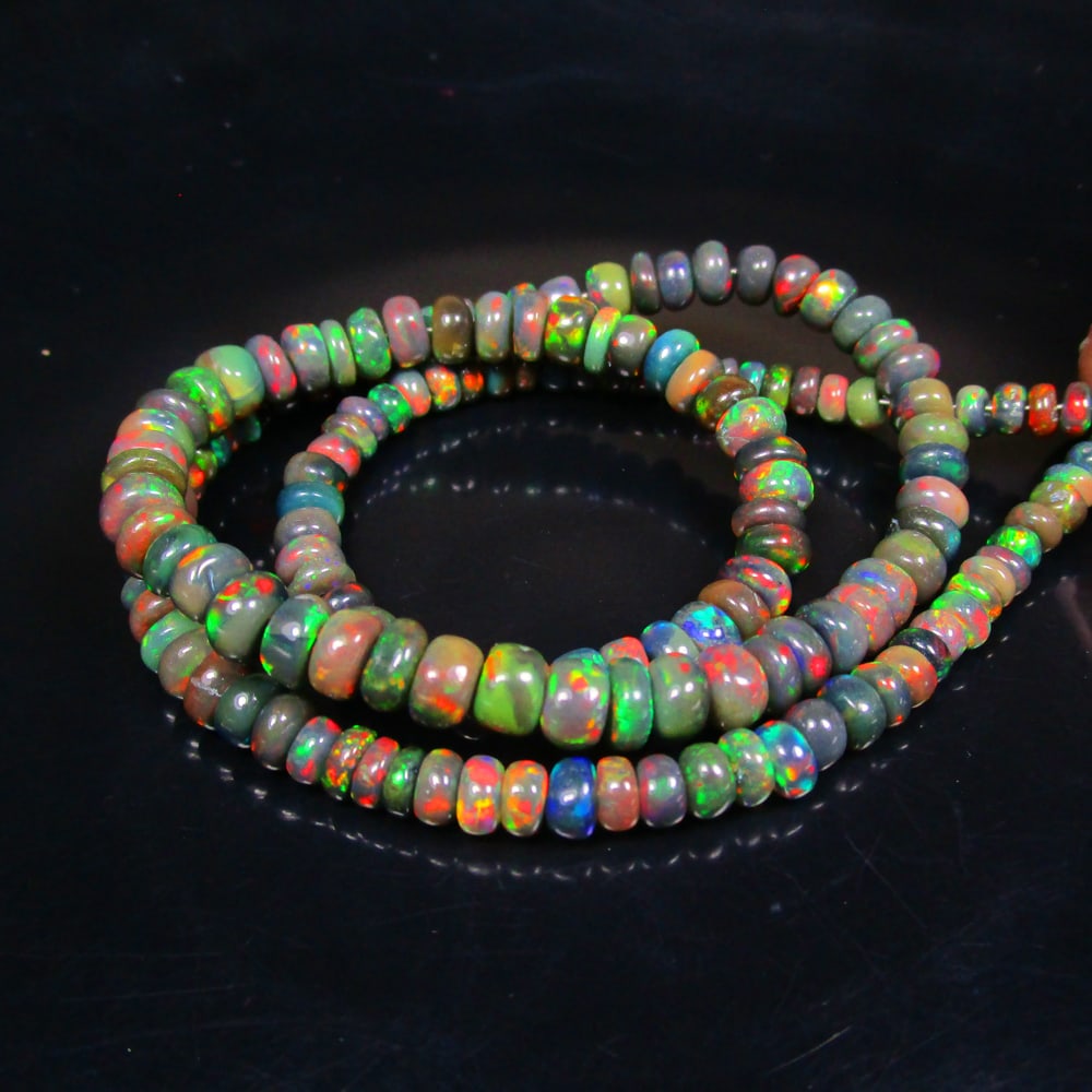 57.39 Ct Natural 158 Black Fire Opal Loose Beads: Weight - 57.39 Ct / Size - 4.10- 5.60 mm / 158 Pc's / Shape - Round Beads / Color - Black / Clarity - Translucent / Origin - Ethiopia / Treatment - Heated