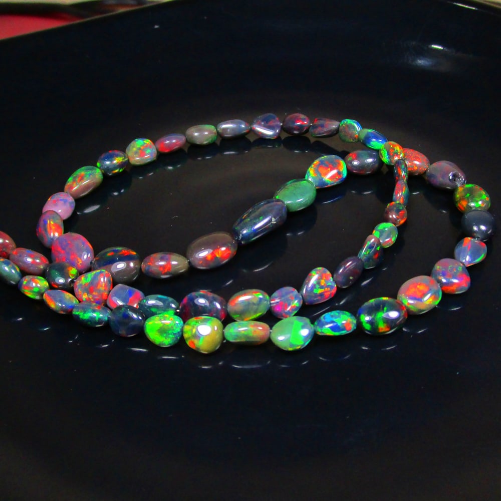 54.70 Ct Natural 58 Black Fire Opal Loose Beads: Weight - 54.70 Ct / Size - 5.8x4.4- 13.1x7.7 mm / 58 Pc's / Shape - Dumble Beads / Color - Black / Clarity - Translucent / Origin - Ethiopia / Treatment - Heated
