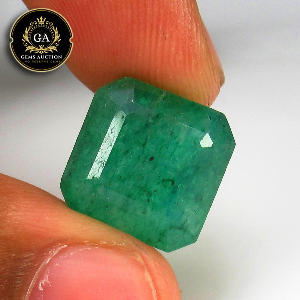 10.75 Ct Coated Grassy Green Emerald Octagon Cut: Weight - 10.75 Ct / Size - 13.50 x 13.50 x 8.00 mm / Shape - Square Octagon Cut / Color - Green / Clarity - SI / Origin - Zambia / Treatment - Colorless Oil