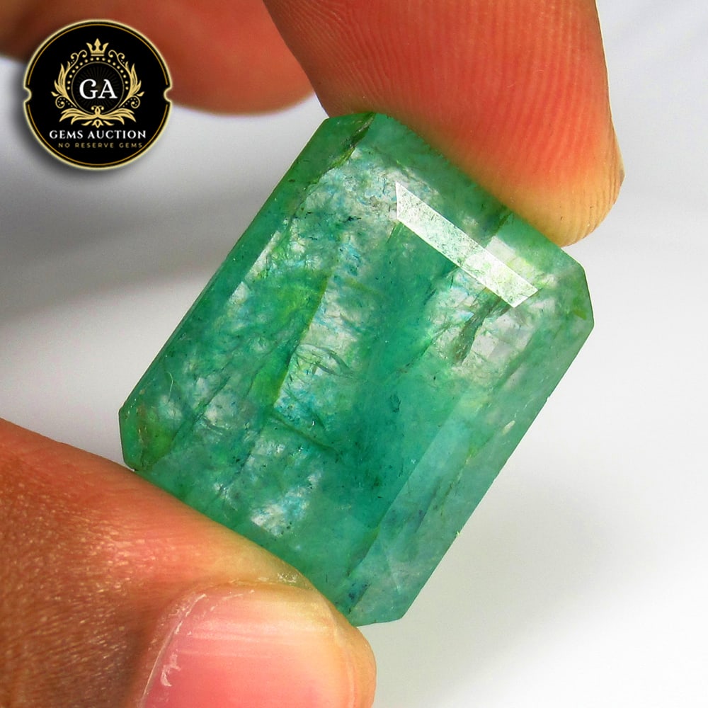 20.70 Ct Coated Grassy Green Emerald Octagon Cut: Weight - 20.70 Ct / Size - 21.00 x 17.70 x 6.30 mm / Shape - Octagon Cut / Color - Green / Clarity - SI / Origin - Zambia / Treatment - Color Coated