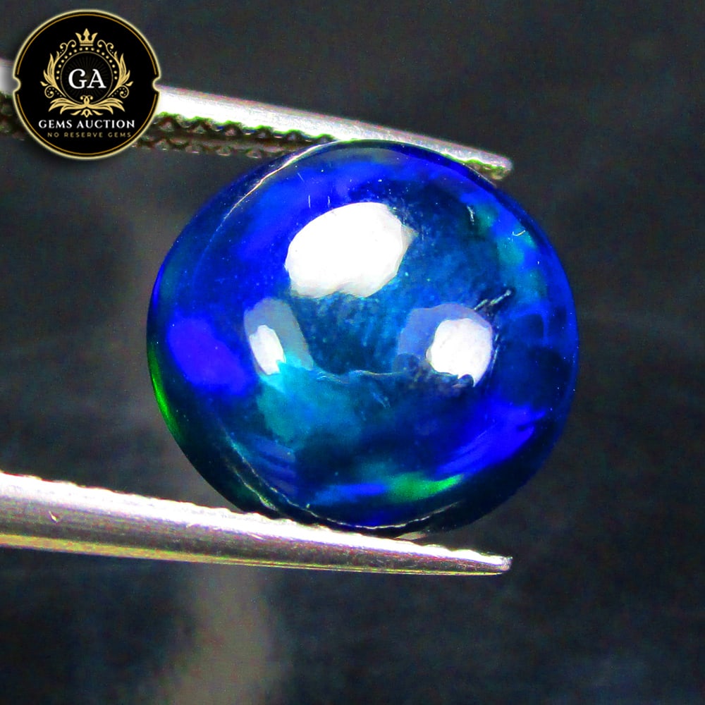 3.55 Ct Natural Black Flashing Fire Opal Round Cab: Weight - 3.55 Ct / Size - 11.40 x 11.20 x 5.70 mm / Shape - Round Cab / Color - Black / Clarity - Translucent / Origin - Ethiopia / Treatment - Heated