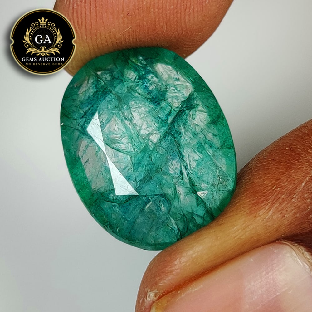 14.67 Ct Natural Grassy Green Emerald Oval Cut: Weight - 14.67 Ct / Size - 19.00 x 15.00 x 7.00 mm / Shape - Oval Cut / Color - Green / Clarity - SI / Origin - Zambia / Treatment - Color Coated