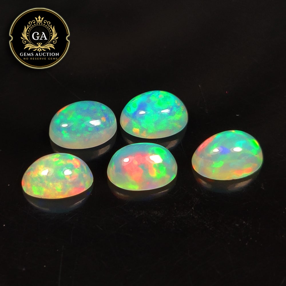 2.89 Ct Natural Multicolor Welo Opal Top Fire Oval Cab Set: Weight - 2.89 Ct / Size - 7.0x5.1 - 7.2x5.3 mm / 5 Pc's / Shape - Oval Cab / Color - Multicolor / Clarity - Translucent / Origin - Ethiopia / Treatment - None