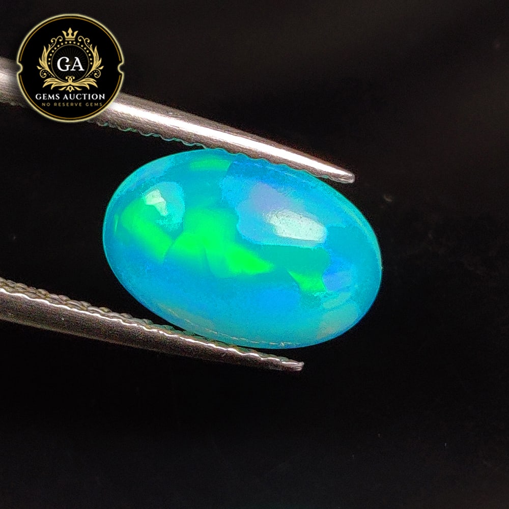 1.53 Ct Natural Blue Fire Opal Oval Cab: Weight - 1.53 Ct / Size - 11.10 x 7.60 x 4.00 mm / Shape - Oval Cab / Color - Blue / Clarity - Translucent / Origin - Ethiopia / Treatment - Heated