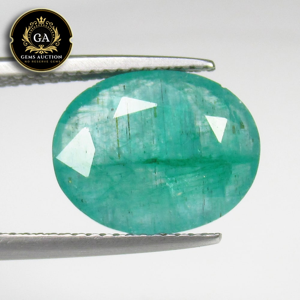 4.93 Ct Natural Green Emerald Oval Cut: Weight - 4.93 Ct / Size -13.30 x 10.80 x 4.60 mm / Shape - OVal Cut / Color - Green / Clarity - SI / Origin - Zambia / Treatment - Color Coated