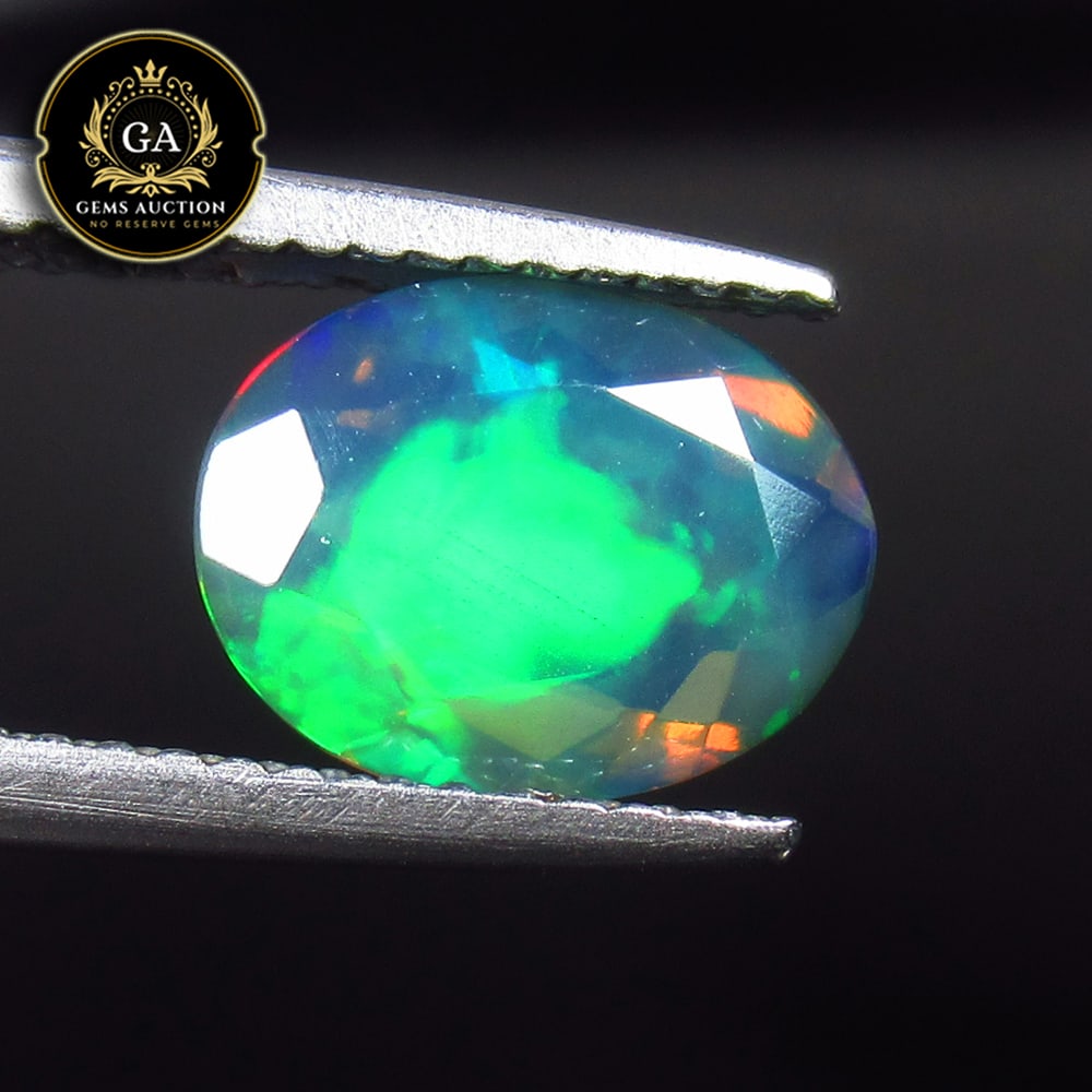 1.49 Ct Natural Black Faceted Fire Opal Oval Cut: Weight - 1.49 Ct / Size - 10.00 x 7.50 x 4.50 mm / Shape - OVal Cut / Color - Black / Clarity - Translucent / Origin - Ethiopia / Treatment - Heated